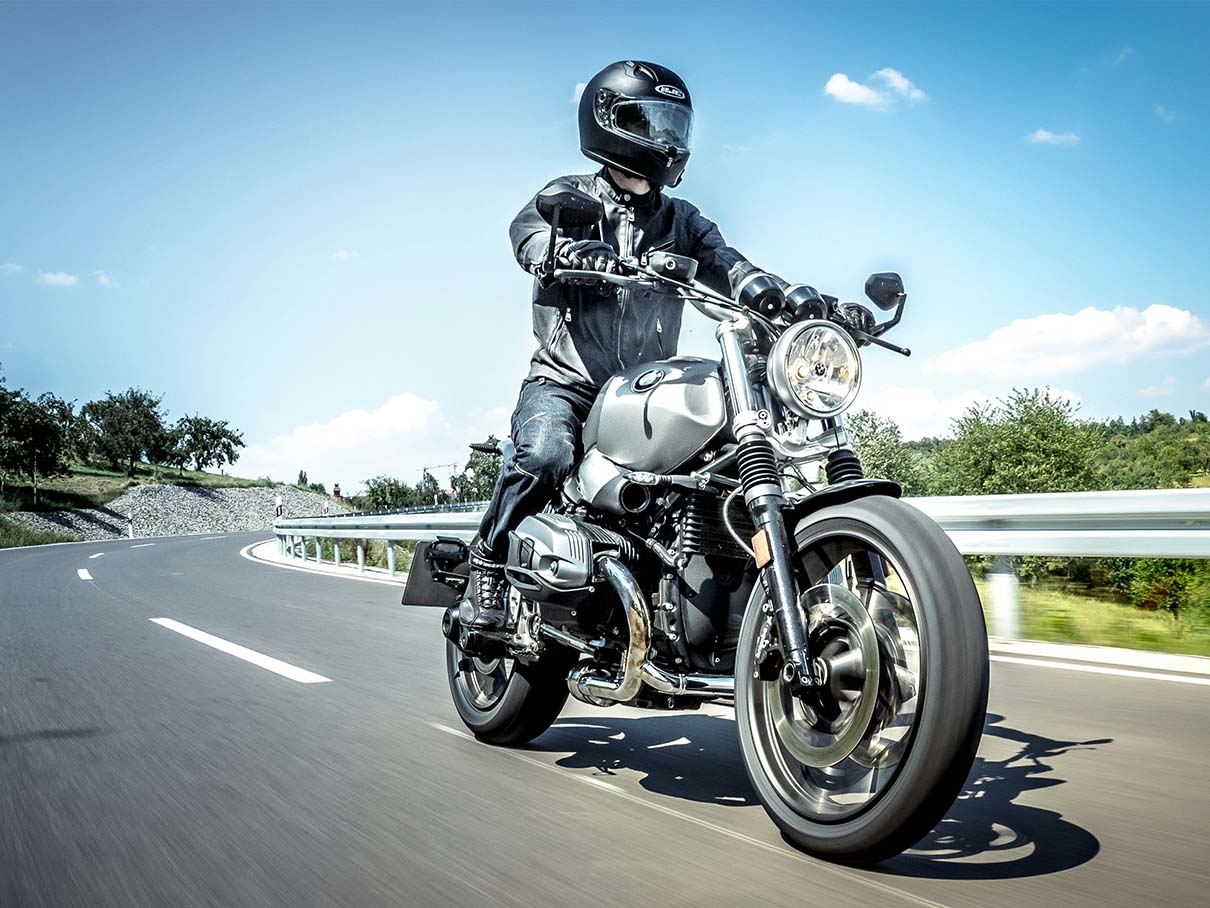 A rider on a motorcycle showing feet on pegs